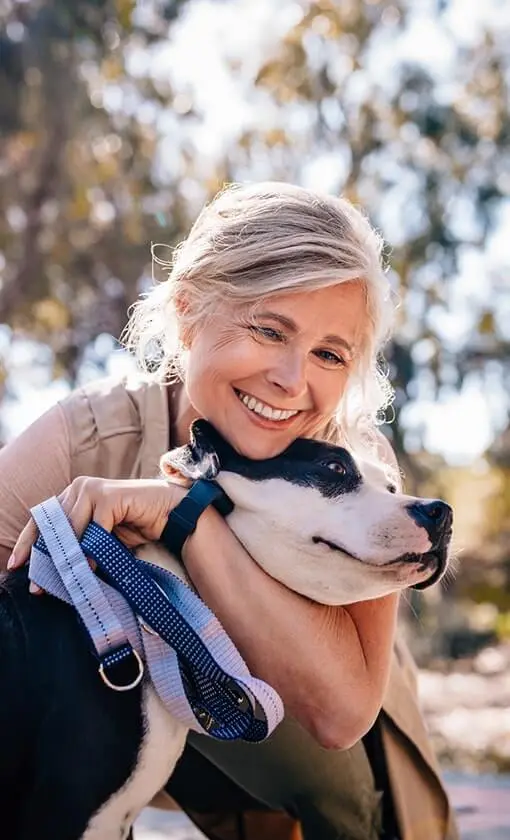 Lady hugging dog